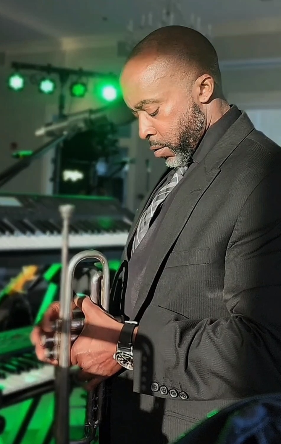 Joe Anderson holding a trumpet during a live performance